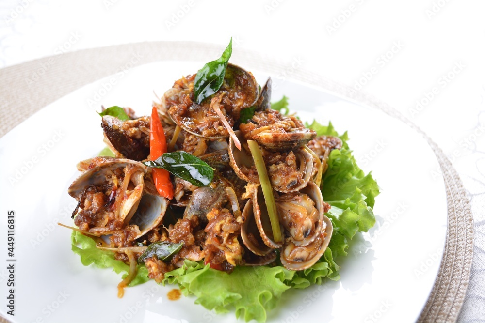 stir fried clam shell seafood with vegetable and chef dry spicy chilli sauce in white background asian halal menu stir fried clam shell seafood with vegetable and chef dry spicy chilli sauce in white background asian halal menu