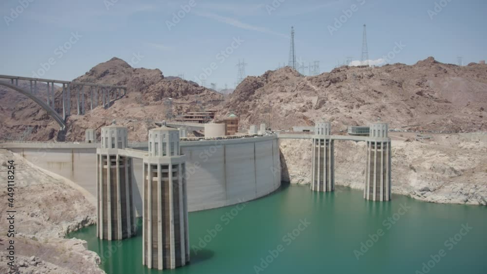 Beautiful Shot Overlooking Hoover Dam in the Daytime With Green and Blue Waters and Scenic Mountain Backdrop in Sow Motion Beautiful Shot Overlooking Hoover Dam in the Daytime With Green and Blue Waters and Scenic Mountain Backdrop in Sow Motion