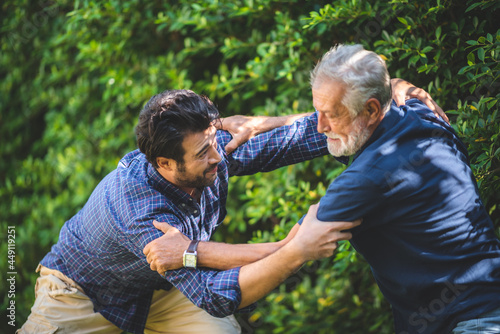 senior father and hipster adult son are happy love and relaxing together at nature outdoor park, mature family of elderly caucasian beard man playing fun with family in retirement leisure time © chokniti