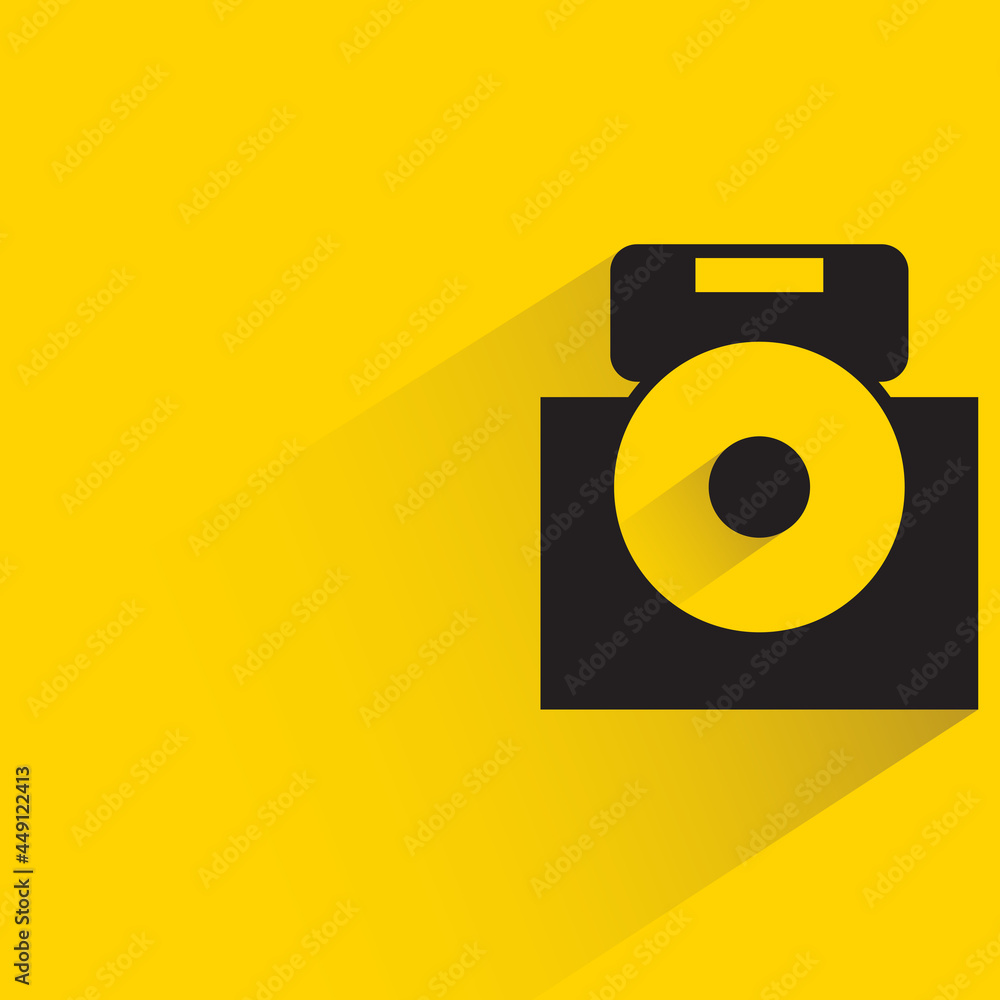 digital camera with shadow on yellow background digital camera with shadow on yellow background