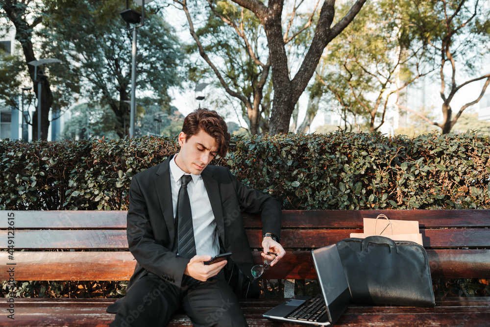 Fototapeta premium young man in casual suit working out in a park outdoors