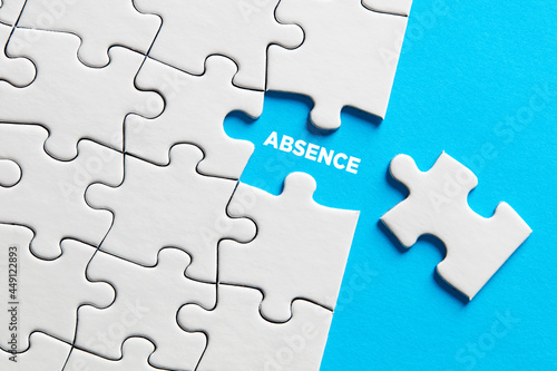The word absence on missing puzzle piece. photo