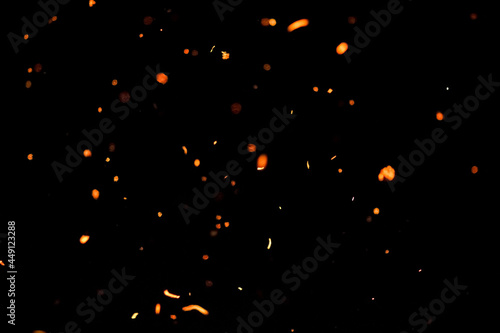 Footage of sparks flying from the fire. Isolated on a black background