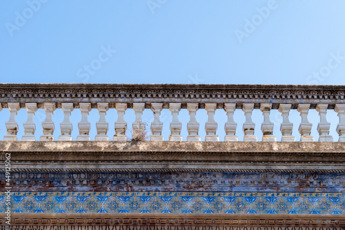 Travel to Portugal. Old vintage facade and balcony from house exterior in Portuguese typical traditional village or city. Hydraulic ceramic tiles