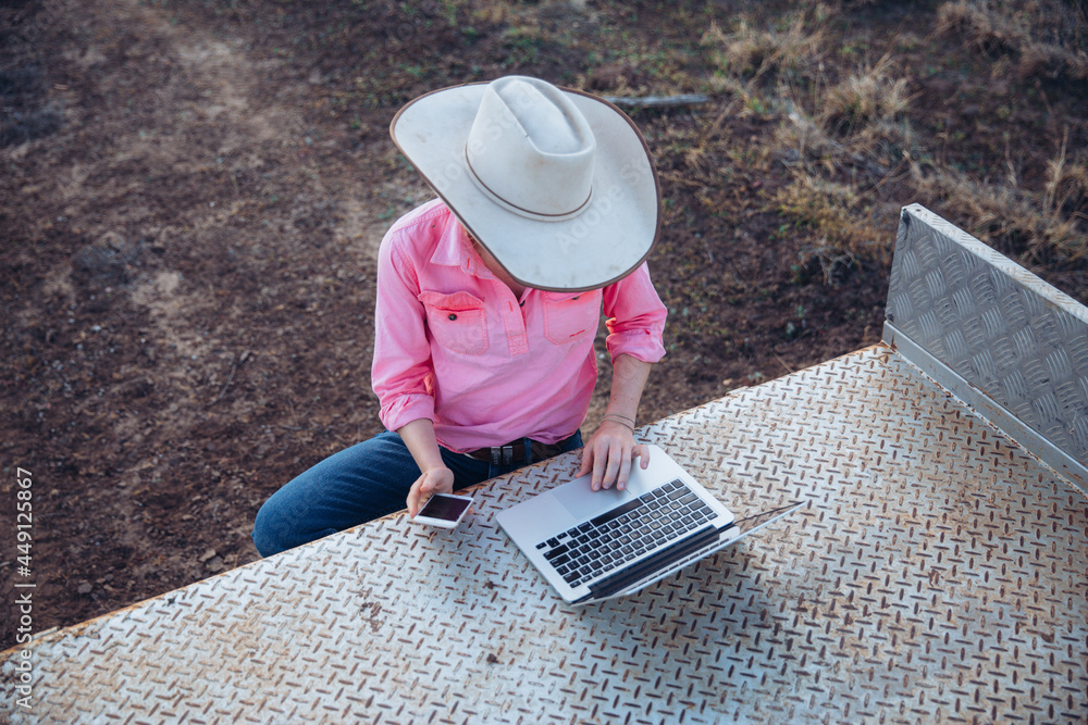 © Austockphoto - Female farmer using telecommunications device