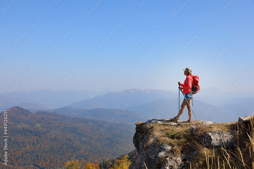 Female tourist with rucksack in mountains