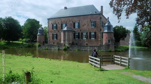 A hiker with backpack looks to the Castle of Erenstein (Kasteel Erenstein) in Kerkrade, Limburg, The Netherlands. photo