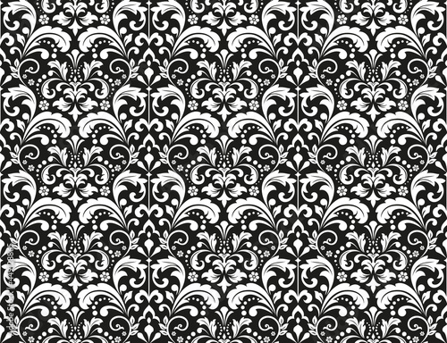 Wallpaper in the style of Baroque. Seamless vector background. White and black floral ornament. Graphic pattern for fabric, wallpaper, packaging. Ornate Damask flower ornament