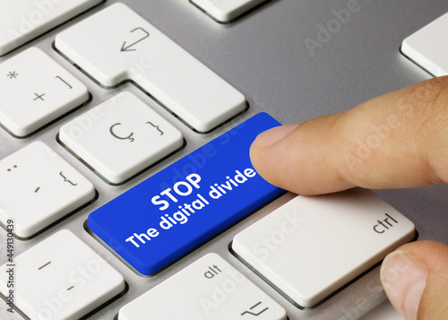 stop the digital divide - Inscription on Blue Keyboard Key. photo