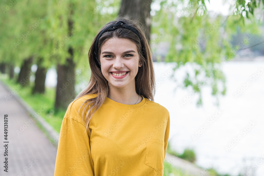 Portrait of a young and attractive Caucasian girl who is standing and looking at camera Portrait of a young and attractive Caucasian girl who is standing and looking at camera