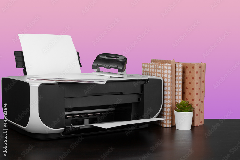 Compact home laser printer against pink background Compact home laser printer against pink background