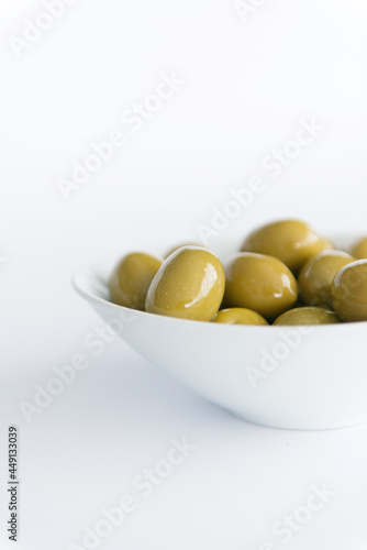 Green Olives In A Bowl on White photo