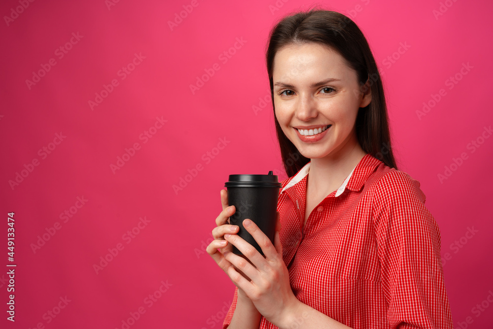 Portrait of attractive young woman with coffee cup against pink background Portrait of attractive young woman with coffee cup against pink background