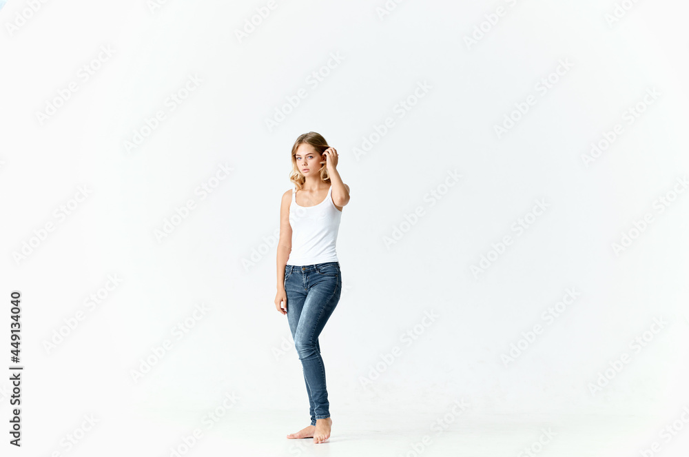 pretty blonde in jeans barefoot posing fashion isolated background pretty blonde in jeans barefoot posing fashion isolated background