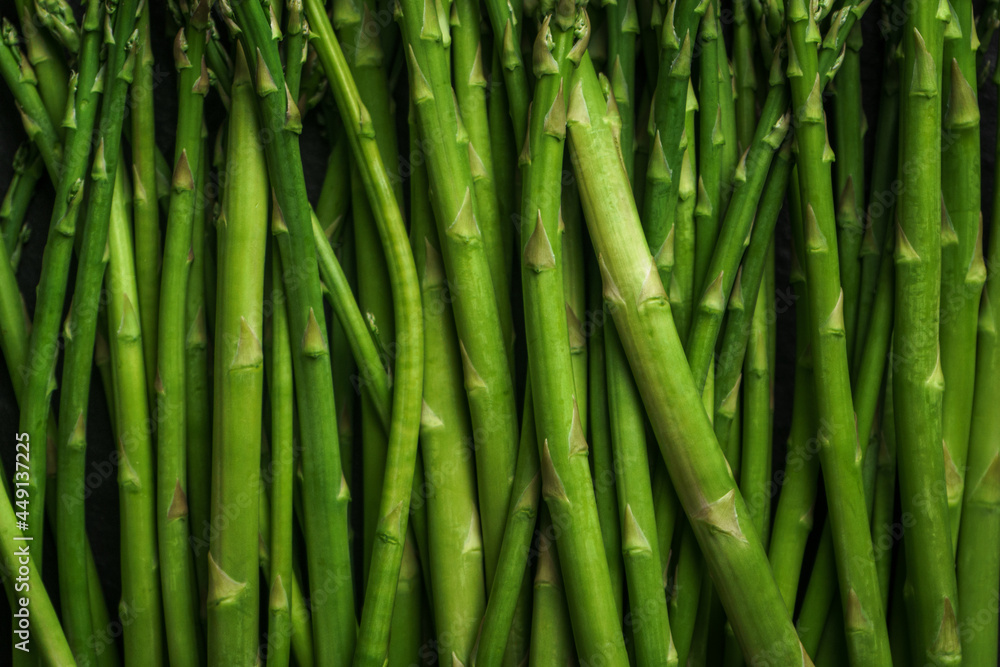 Asparagus from the garden on black stone background Asparagus from the garden on black stone background