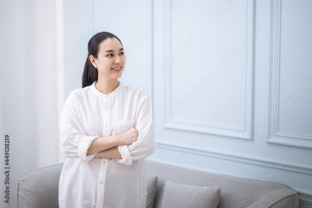 Portrait of successful business asian women in white shirt. with arms crossed and smile , Young businesswoman smiling and looking away Happy feeling concept Portrait of successful business asian women in white shirt. with arms crossed and smile , Young businesswoman smiling and looking away Happy feeling concept