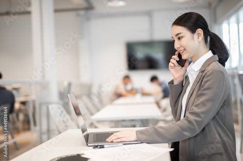 Asian woman celebrate with laptop, success happy pose. E-commerce, University education, internet Technology, or startup small business concept. Modern office or living room with copy space