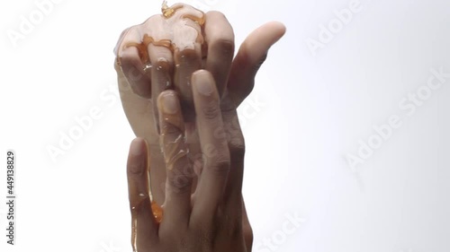 Honey poured on hands, rubbing in