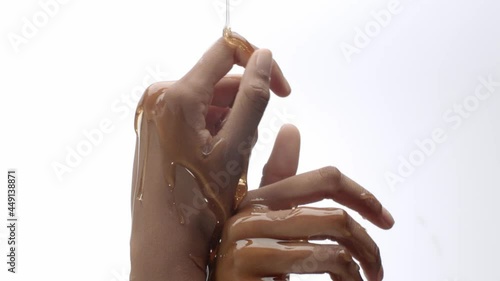 Honey poured on hands, rubbing in