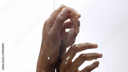 Honey poured on hands, rubbing in