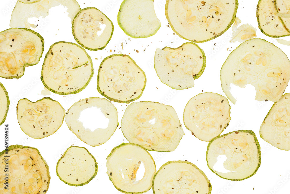Dried slices zucchini or courgette with salt and spices over white background