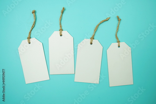 Flat lay White Blank Tag on blue background