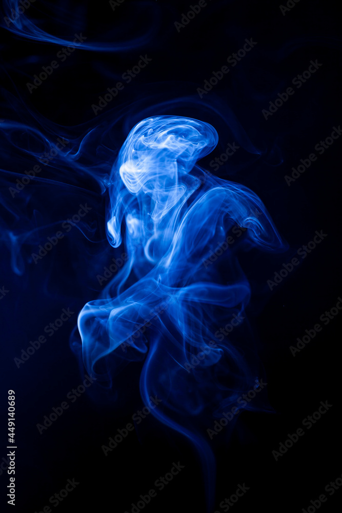 Fototapeta premium Motion blue smoke on black background.
