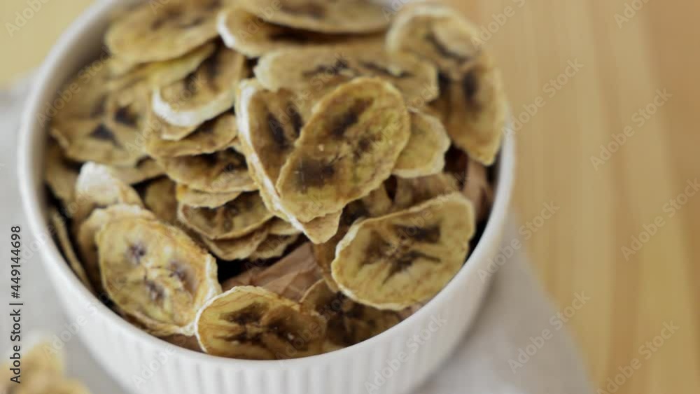 dried banana on white textile background.Homemade Dehydrated Banana Chips dried banana on white textile background.Homemade Dehydrated Banana Chips