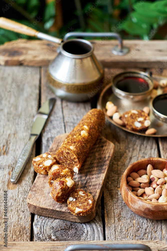 Fig and nut salami. Healthy vegan candy. Coffee