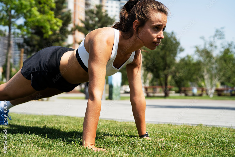 Young sporty woman training in the park. Beautiful woman in sportswear working out. Young sporty woman training in the park. Beautiful woman in sportswear working out.