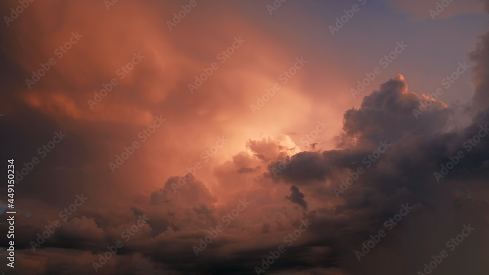 Bright purple and pink sky with clouds of a sunset or sunrise background. Twilight sky background with Colorful sky. Dramatic sky. Аir and fluffy clouds as a concept of hope.