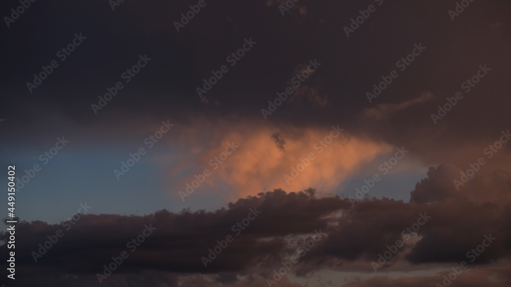 Bright purple and pink sky with clouds of a sunset or sunrise background. Twilight sky background with Colorful sky. Dramatic sky. Аir and fluffy clouds as a concept of hope.