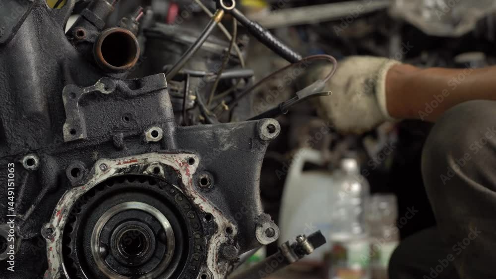 Internal combustion engine, diesel fuel, close-up. He's covered in black oil. It will be repaired or disposed of for scrap. car disassembly or repair of the car. Hands of master close-up. repairman. Internal combustion engine, diesel fuel, close-up. He's covered in black oil. It will be repaired or disposed of for scrap. car disassembly or repair of the car. Hands of master close-up. repairman.