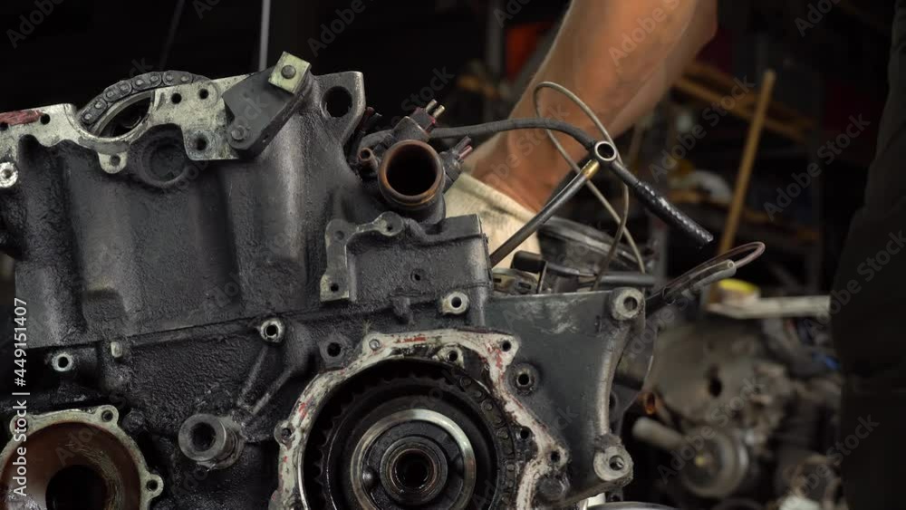 Internal combustion engine, diesel fuel, close-up. He's covered in black oil. It will be repaired or disposed of for scrap. car disassembly or repair of the car. Hands of master close-up. repairman. Internal combustion engine, diesel fuel, close-up. He's covered in black oil. It will be repaired or disposed of for scrap. car disassembly or repair of the car. Hands of master close-up. repairman.