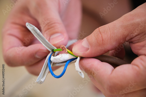 Photos Young man hands repairing or splicing wires.