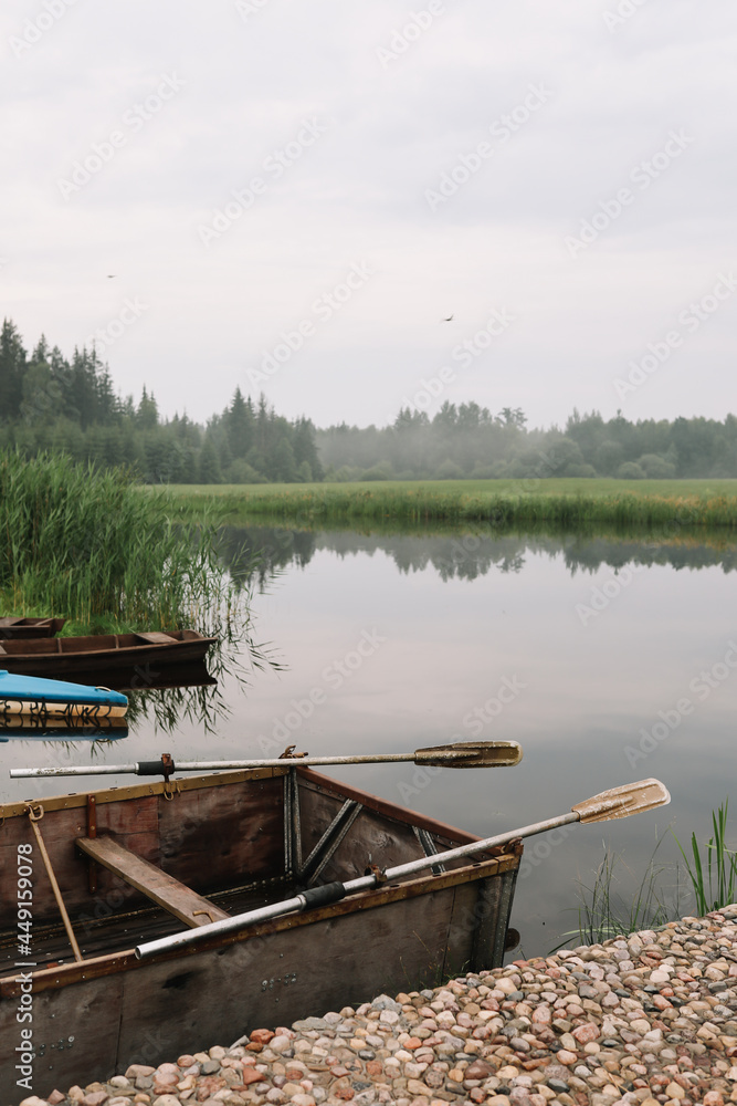 wooden boat by the pier on the lake wooden boat by the pier on the lake