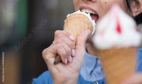 Close up of woman eating ice cream on street 