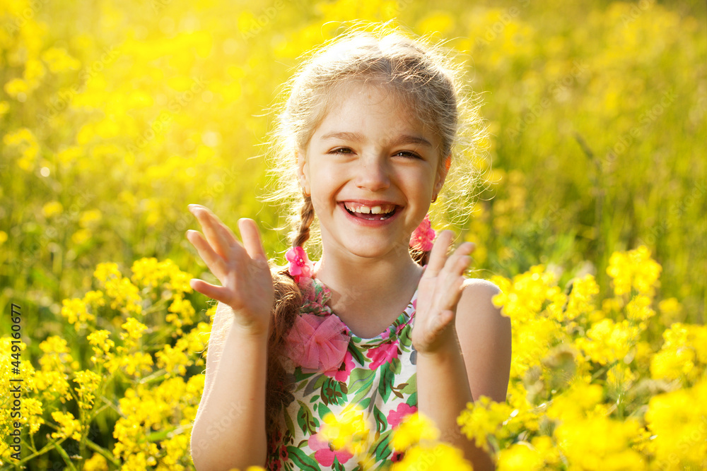 Happy little girl among yellow wildflowers Happy little girl among yellow wildflowers