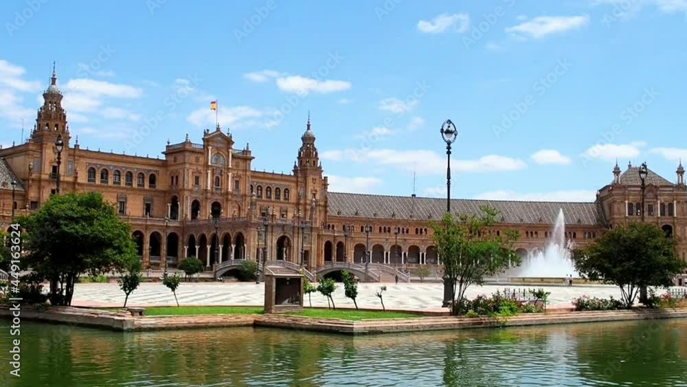 View of Plaza España (Seville, Spain) with fountain and tourist walking View of Plaza España (Seville, Spain) with fountain and tourist walking