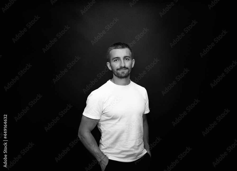 Fototapeta premium handsome and smiling guy on a black background
