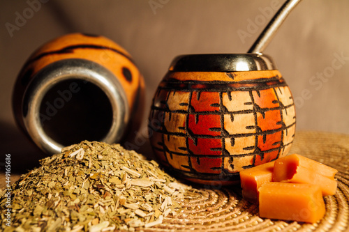 Yerba mate-South American tea, dried leaves in wooden bowl with a wooden mate calabash with tea