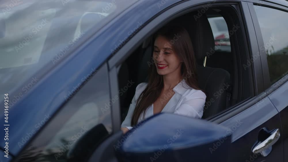 Young woman sits of a drivers seat and smiles Young woman sits of a drivers seat and smiles