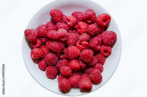 raspberries in a bowl on a white background, background with raspberries, freshly picked raspberries