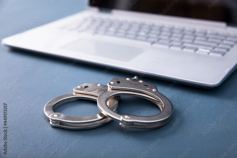 Laptop and handcuffs Laptop and handcuffs