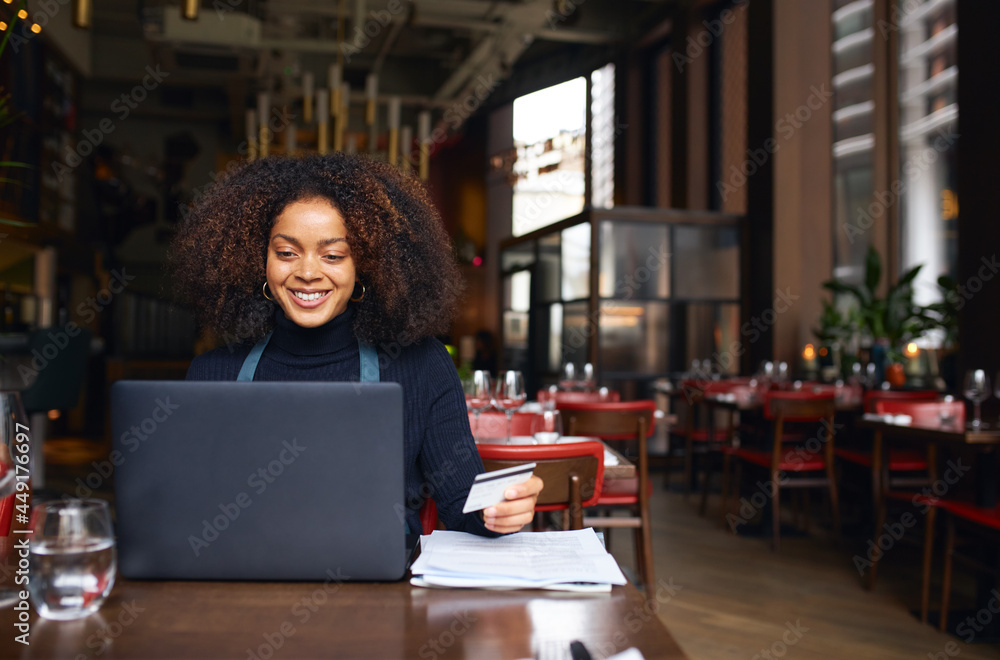 Portrait of restaurant owner using laptop Portrait of restaurant owner using laptop