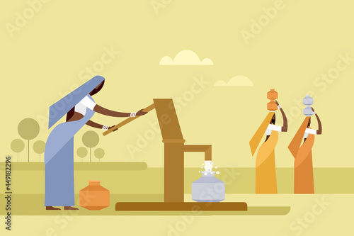 Indian rural women collecting water from a tube well using hand pump