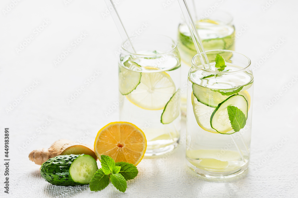 Sassi water. Detox drink with lemon, cucumber, ginger and mint. Healthy food concept. Glass straws Sassi water. Detox drink with lemon, cucumber, ginger and mint. Healthy food concept. Glass straws