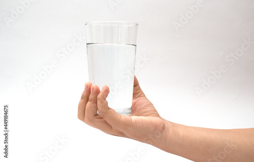 holding a glass cup on a white background