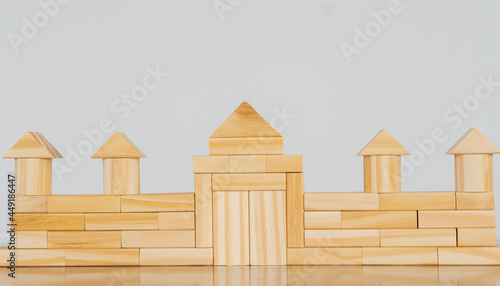 Empty wooden blocks on the table placed as a wall  white background  protection concept.
