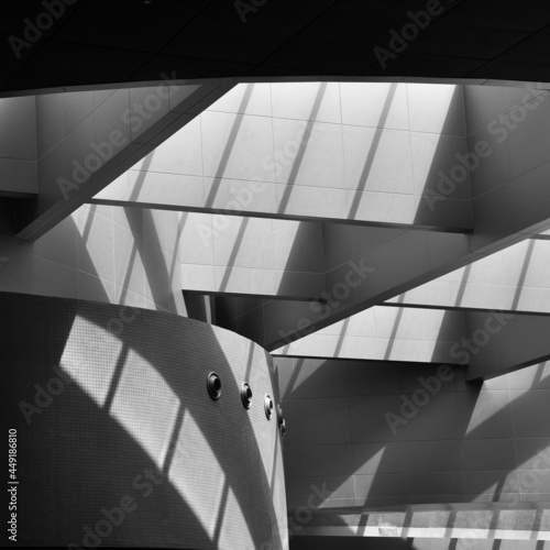 An abstract architectural background pattern. Black and white photo of an interior building with solid beam  structure.